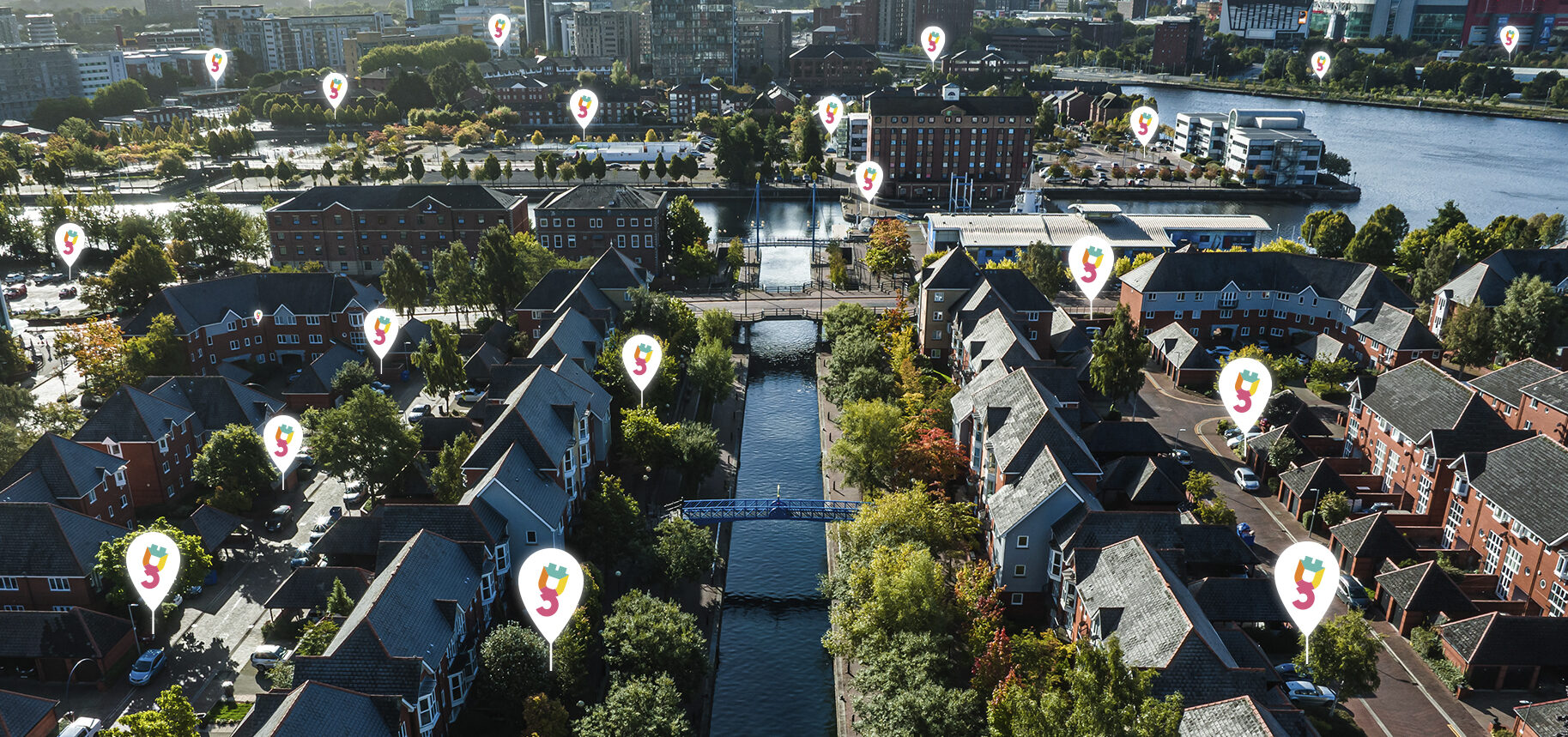 GoPlugable pinpoints showing chargepoints over a sky view of Manchester